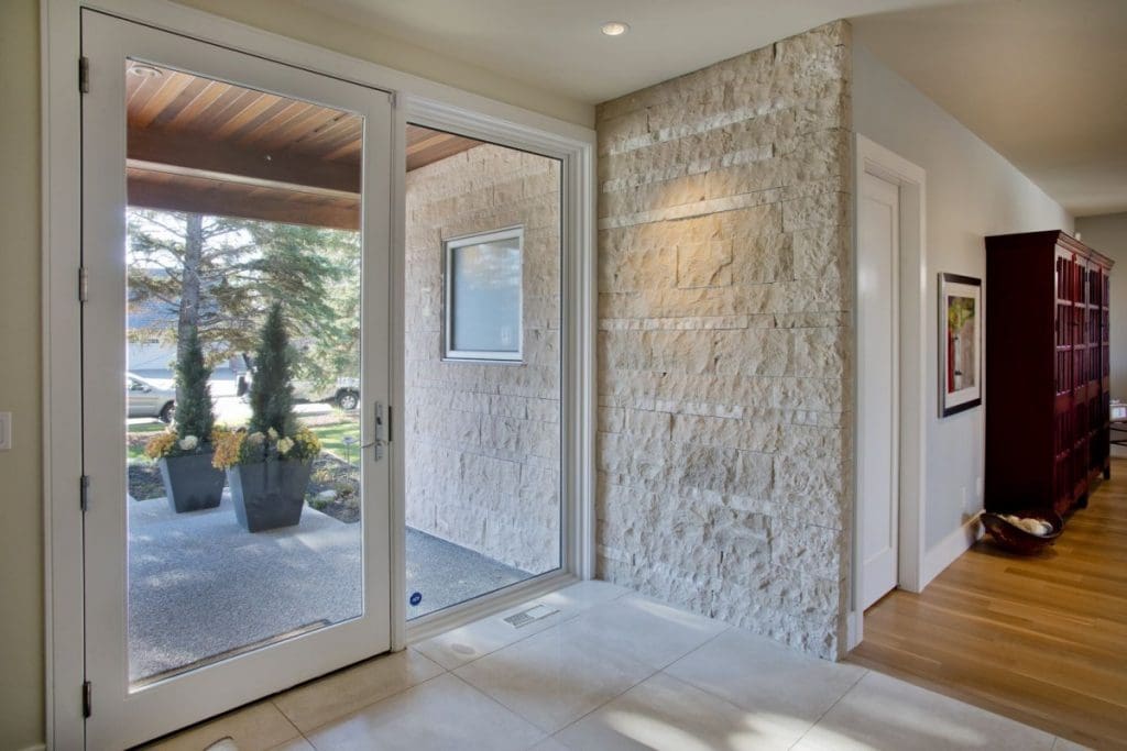 Bayview home by renova homes and renovations front entry, bringing the stone from outside into the home