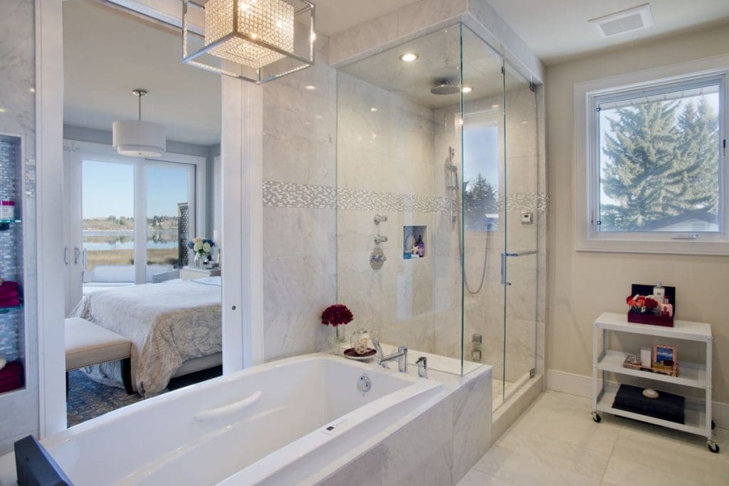 Bayview Whole Home Project By Renova Homes & Renovations Calgary, Alberta master ensuite with sunken tub and walk in tiled shower leading into master bedroom