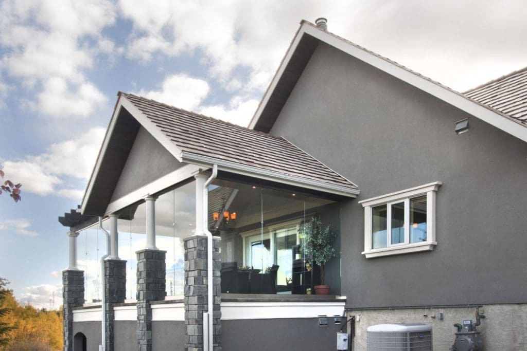 Bearspaw Exterior Project By Renova Homes & Renovations Calgary, Alberta exterior showcasing glass walls on upper patio