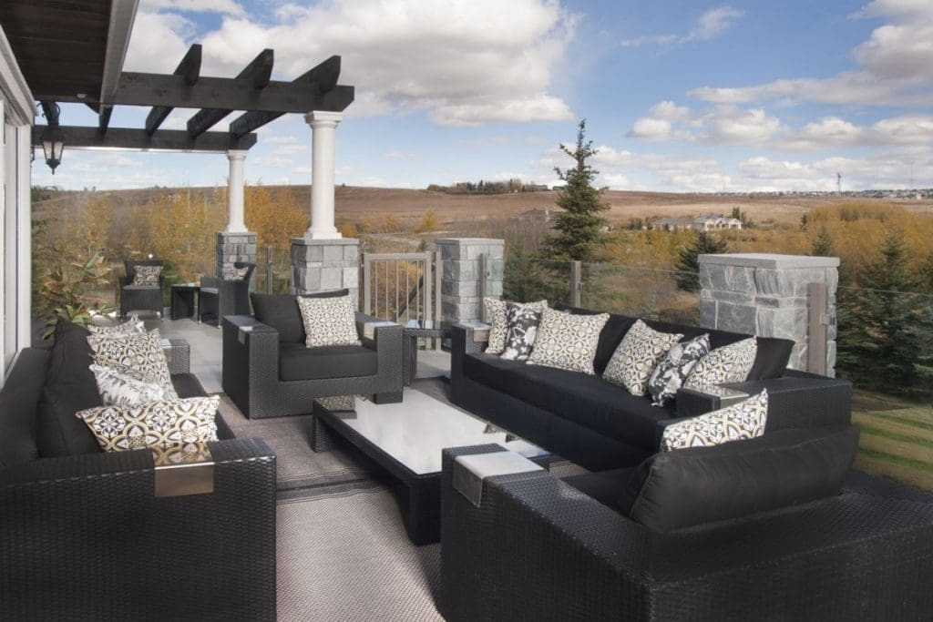 Bearspaw exterior with custom railing by renova homes and renovations