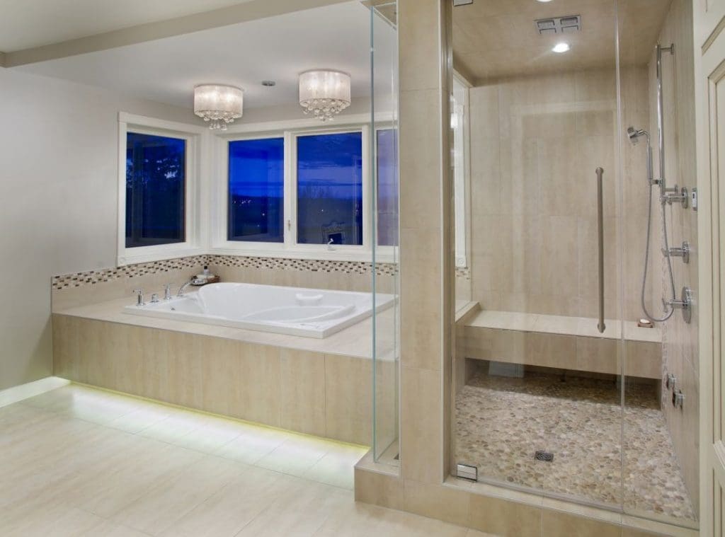 Bearspaw Project By Renova Homes & Renovations Calgary, Alberta master bedroom ensuite with tiled walk in steam shower and sunken bathtub for relaxation