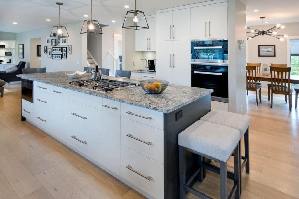 Canyon Meadows Project By Renova Homes & Renovations Calgary, Alberta with two-toned island leading into living space