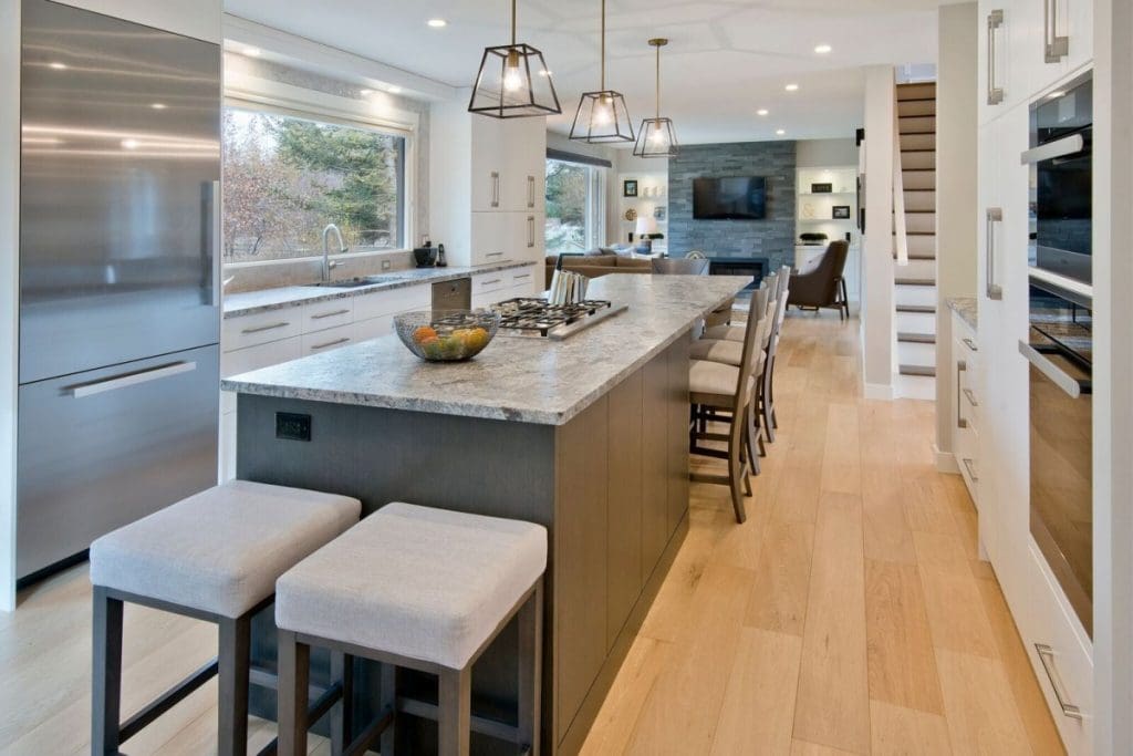 Renova Homes and Renovations Kitchen island and living room with hardwood floors