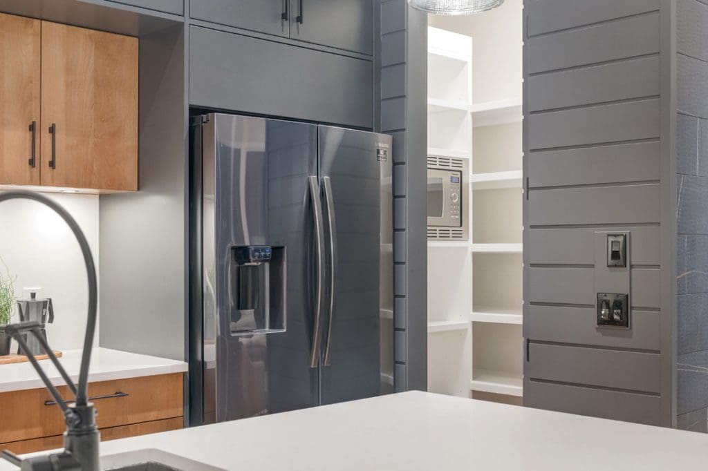 Townhome by renova homes and renovations kitchen with custom cabinetry and appliances