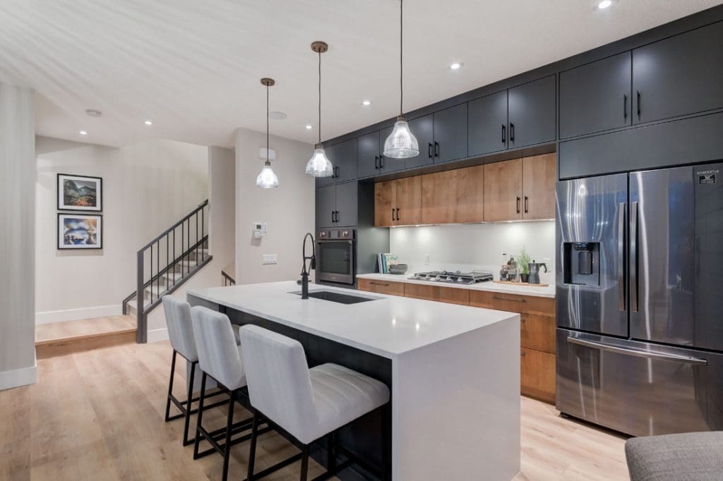 Townhomes custom kitchen with quartz countertop and two toned cabinets