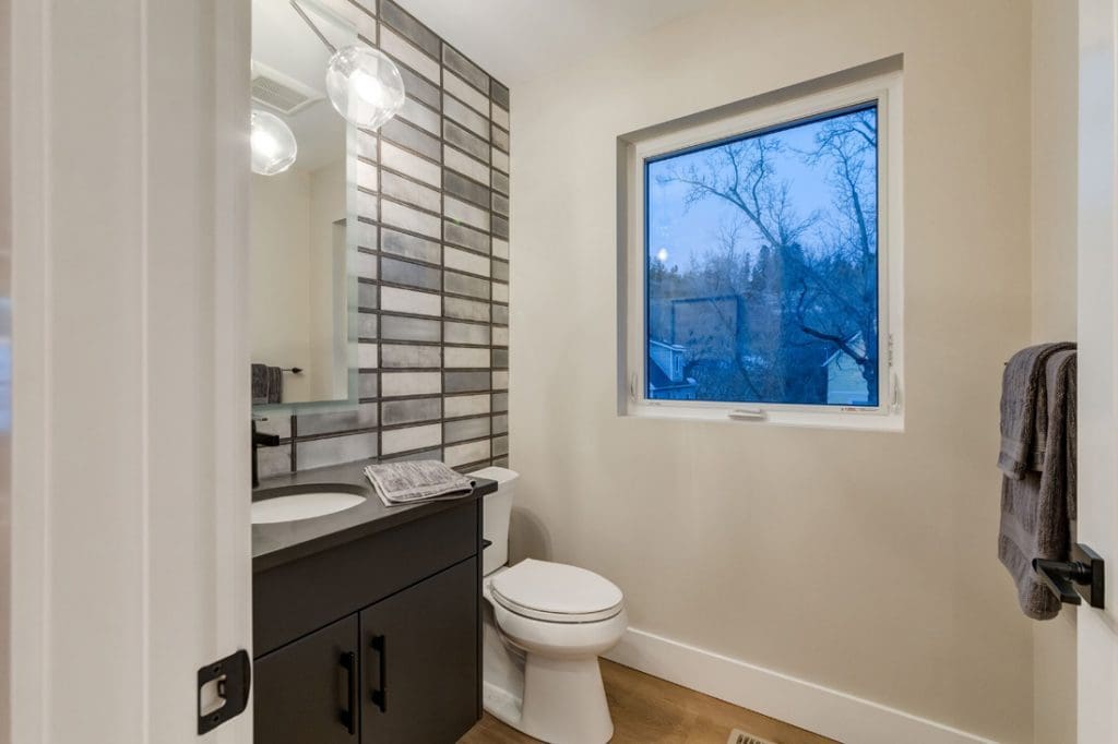 Custom bathroom with tile wall and custom black canity