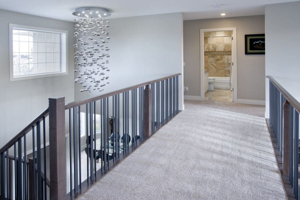 Edgemont upstairs floor landing with balcony over living room and bubbly chandelier