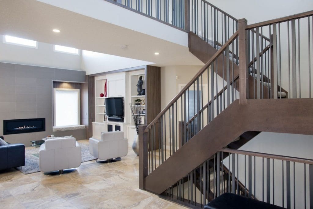 Edgemont Contemporary Twist Project By Renova Homes & Renovations Calgary, Alberta foyer with large wooden railings leading into the living room