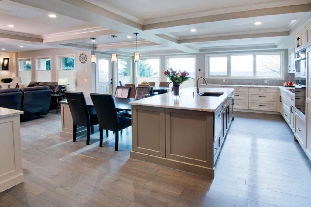 Edgemont Project Two By Renova Homes & Renovations Calgary, Alberta kitchen island with parameter cabinetry and a wall of windows creating tons of natural light