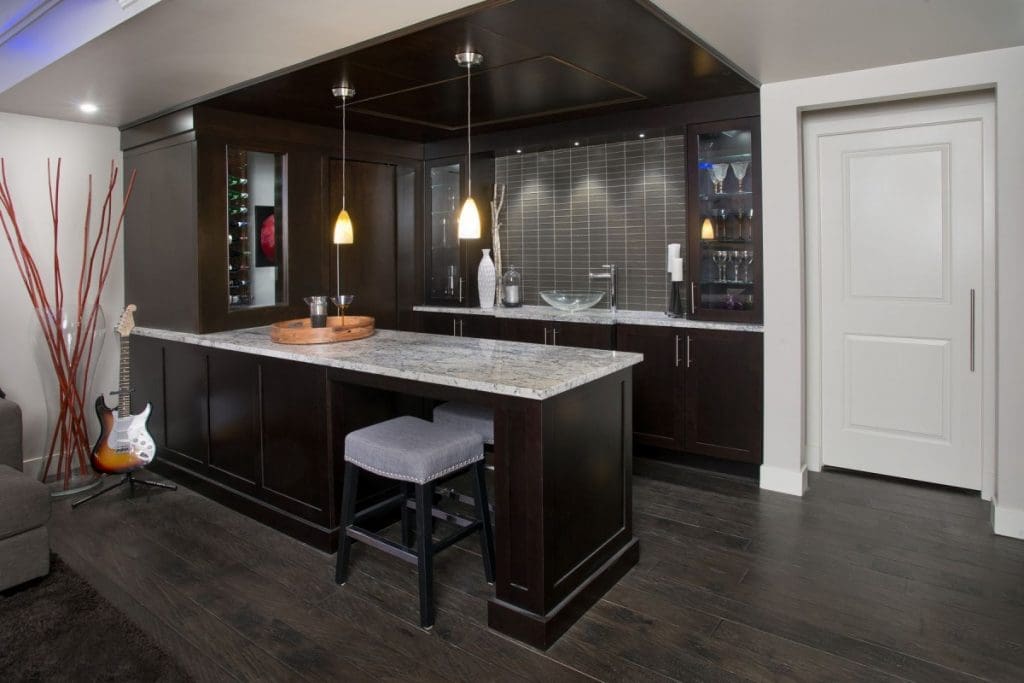 Hamptons Basement Project By Renova Homes & Renovations Calgary, Alberta wet bar with a modern rocker edge