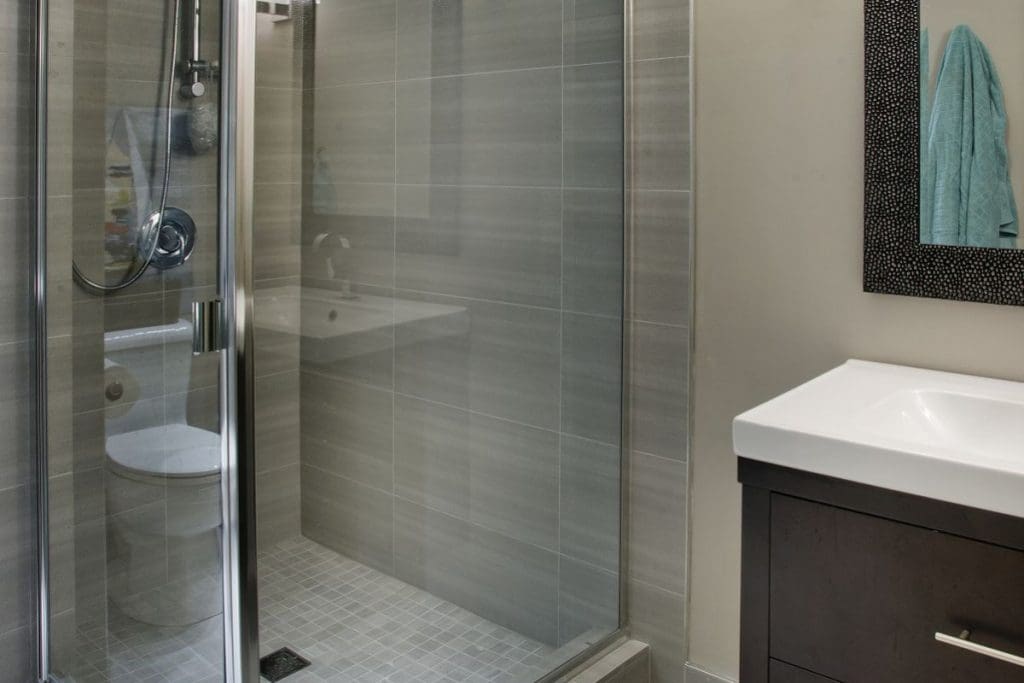 Hamptons Basement Project By Renova Homes & Renovations Calgary, Alberta bathroom with tiled shower and new vanity