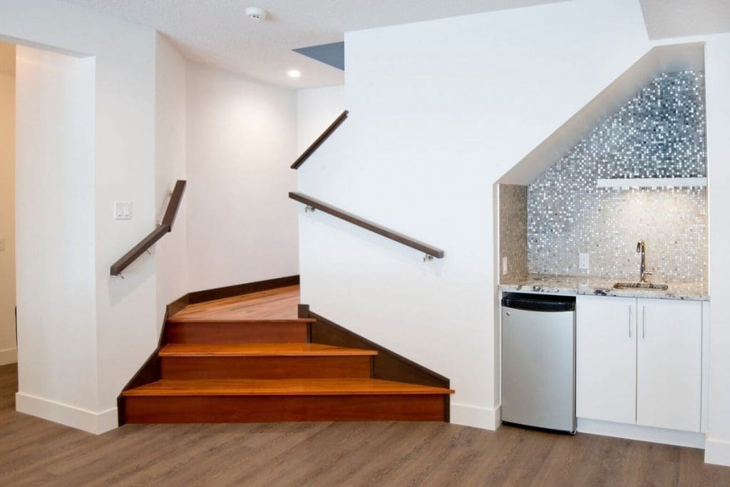 Hawkwood Renovation Project By Renova Homes & Renovations Calgary, Alberta grand staircase leading into a downstairs haven