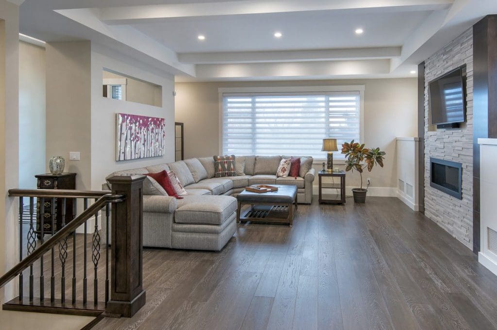 Hounsfield Heights Custom Home By Renova Homes & Renovations Calgary, Alberta spacious living room with grans tv mounted on the wall
