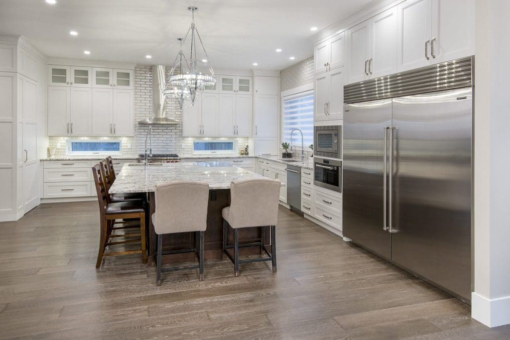 Hounsfield Heights Custom Home By Renova Homes & Renovations Calgary, Alberta with a stunning marble countertop island and custom floor to ceiling cabinets