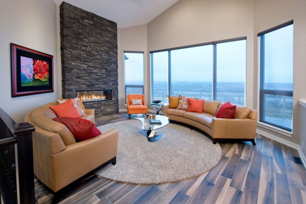 Mckenzie living rooms with floor to ceiling windows and new stone fireplace by renova homes and renovations
