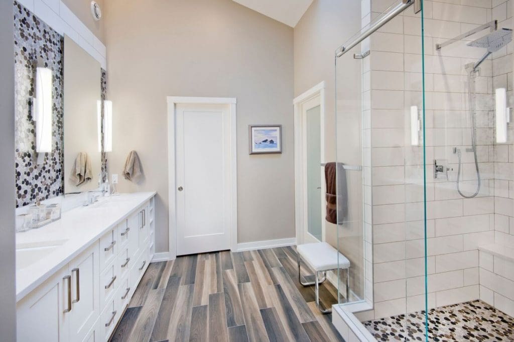 Mckenzie Renovation By Renova Homes & Renovations Calgary, Alberta master ensuite with tiled shower and laminate flooring
