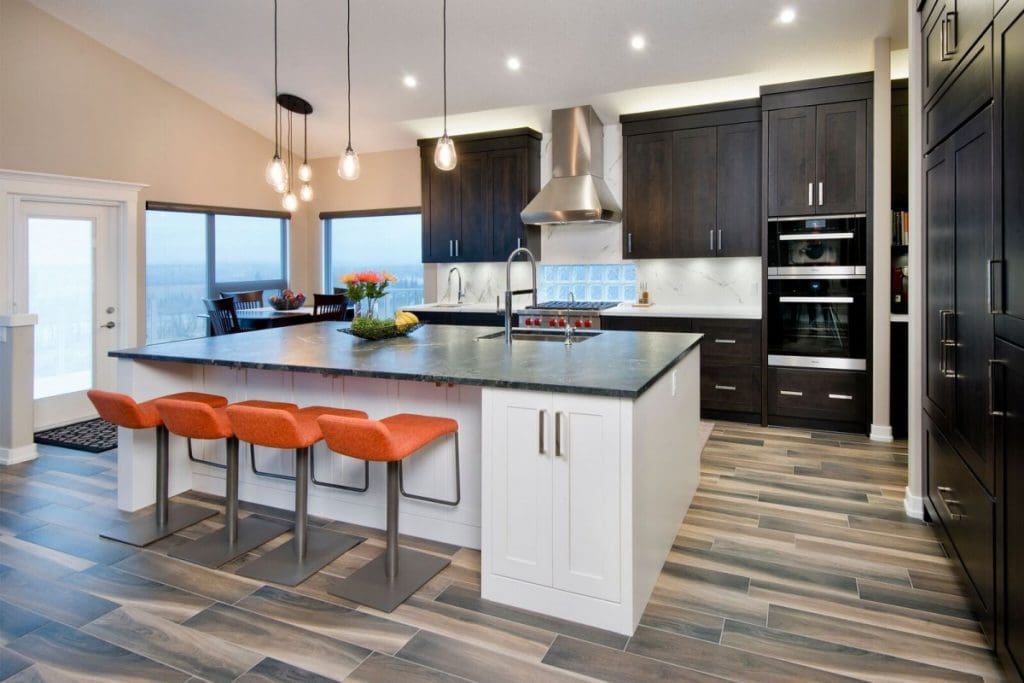 Kitchen renovation with two toned cabinetry thorughout and marble back splash by renova homes and renovations