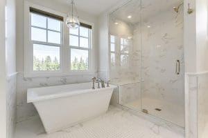 Mount Royal Custom Home master bedroom ensuite stand alone bathub with a marble tile shower By Renova Homes & Renovations Calgary, Alberta