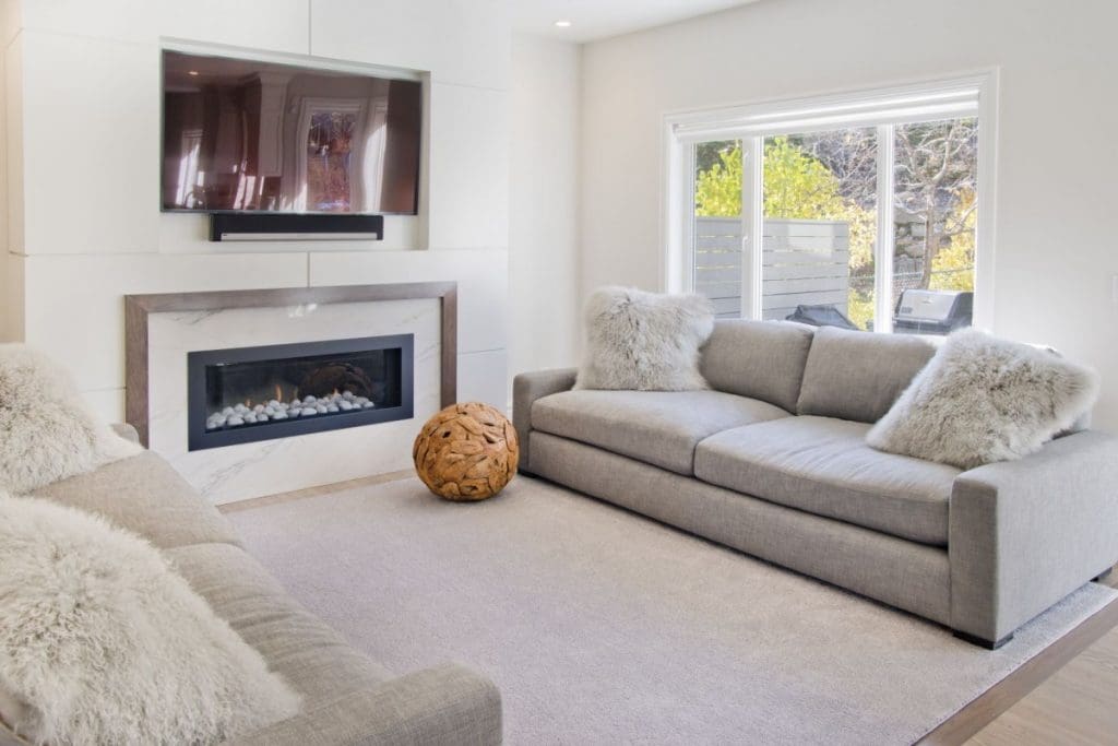 Patterson Interior Project By Renova Homes & Renovations Calgary, Alberta living room with tiled fireplace and spacious living