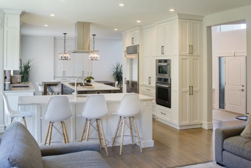 Patterson Interior Project By Renova Homes & Renovations Calgary, Alberta beautiful kitchen spanning into the living room with bright natural light