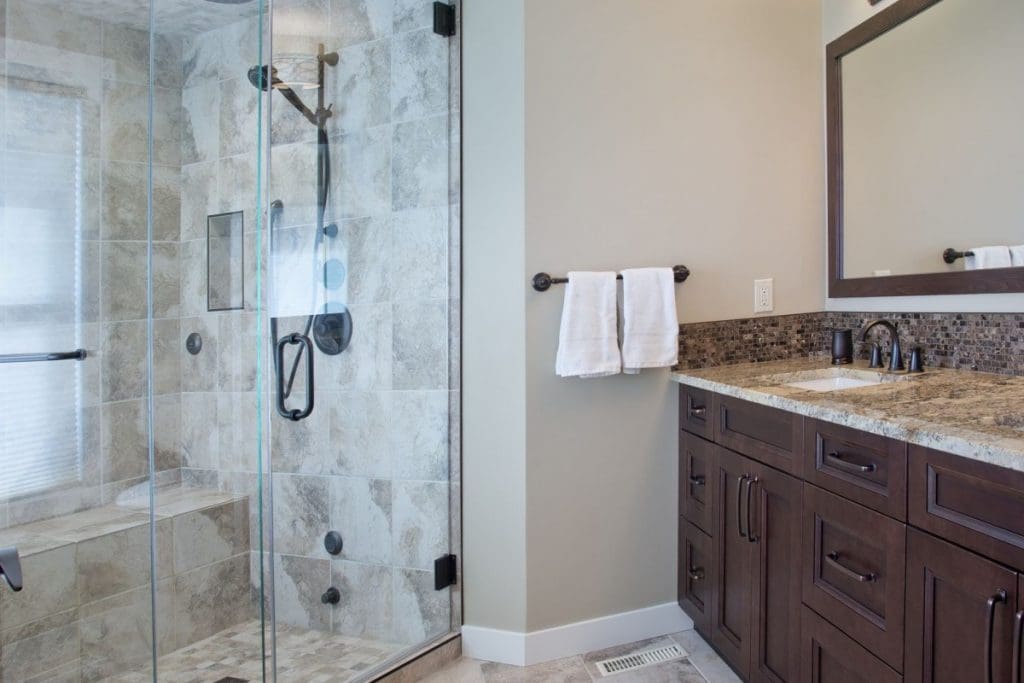 Scenic Acres Main Floor Project By Renova Homes & Renovations Calgary, Alberta bathroom with tiled steam shower and quartz countertops on the vanity