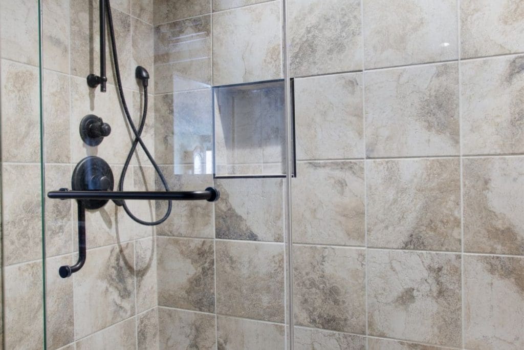 Scenic acres tile shower renovation with black hardware