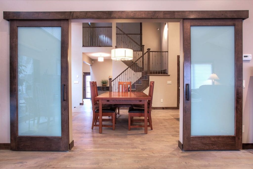 Silversprings Project By Renova Homes & Renovations Calgary, Alberta dining room framed by two sliding doors