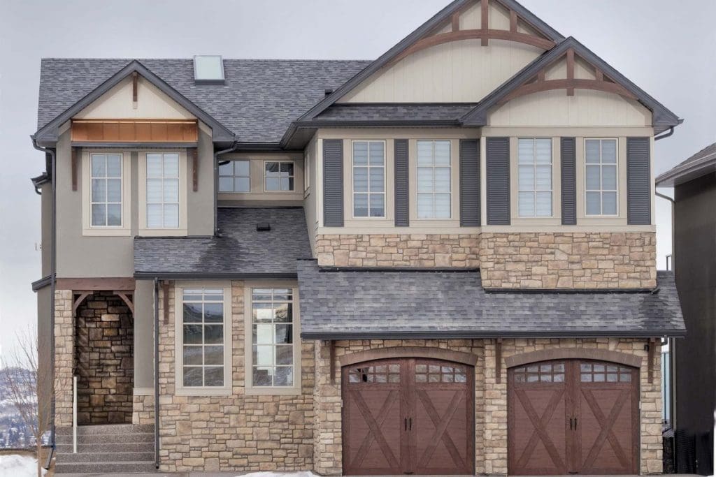 Exterior renovation in sowuthwest calgary by renova homes and renovations with beautiful stone work and stucco throughout