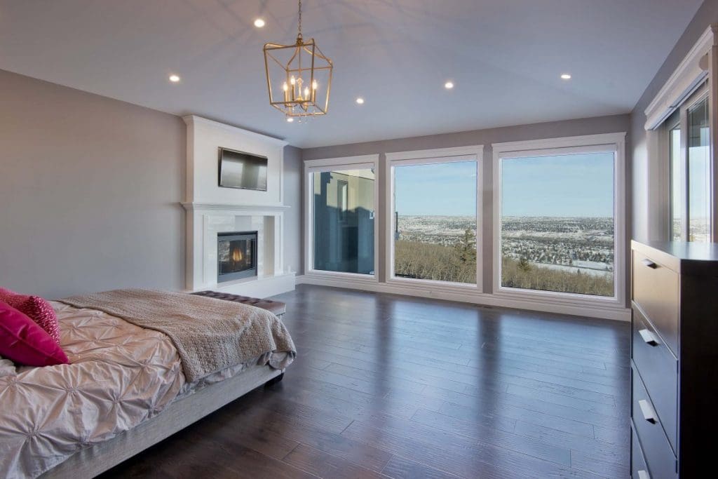 Southwest Calgary Custom Home By Renova Homes & Renovations Calgary, Alberta master bedroom looking out onto edworthy park calgary with floor to ceiling windows