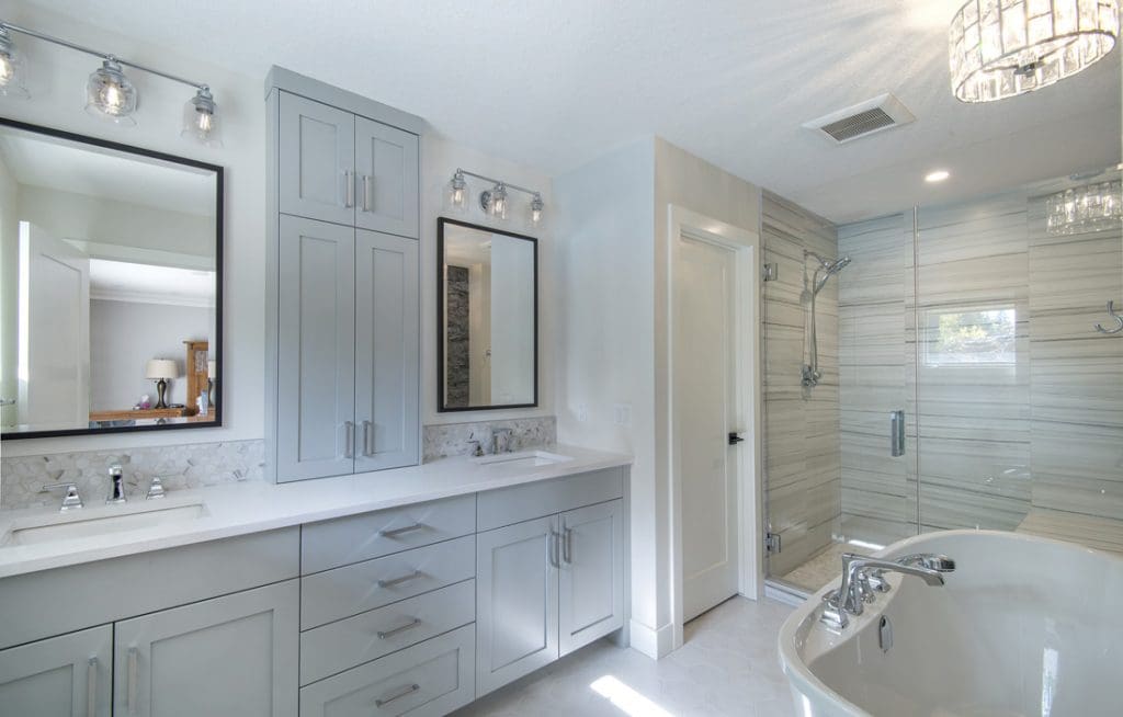 Springbank calgary ensuite renovation with baby cloud blue cabinets with custom tiled shower and stand alone bathtub