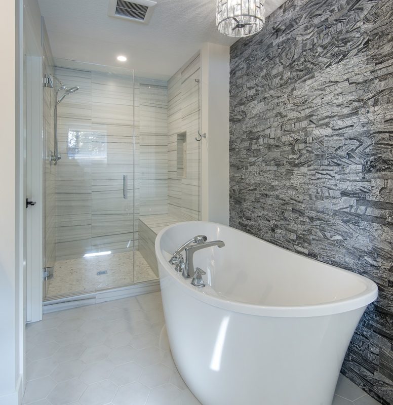 Springbank ensuite with tiled shower and stand alone tub By Renova Homes & Renovations Calgary, Alberta