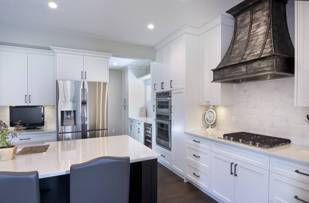 Tuscany Project kitchen with mixed metal hoodfan By Renova Homes & Renovations Calgary, Alberta