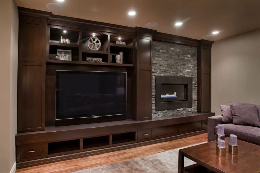 Wentworth Project By Renova Homes & Renovations In Calgary, Alberta basement tv room with fire place and stonework