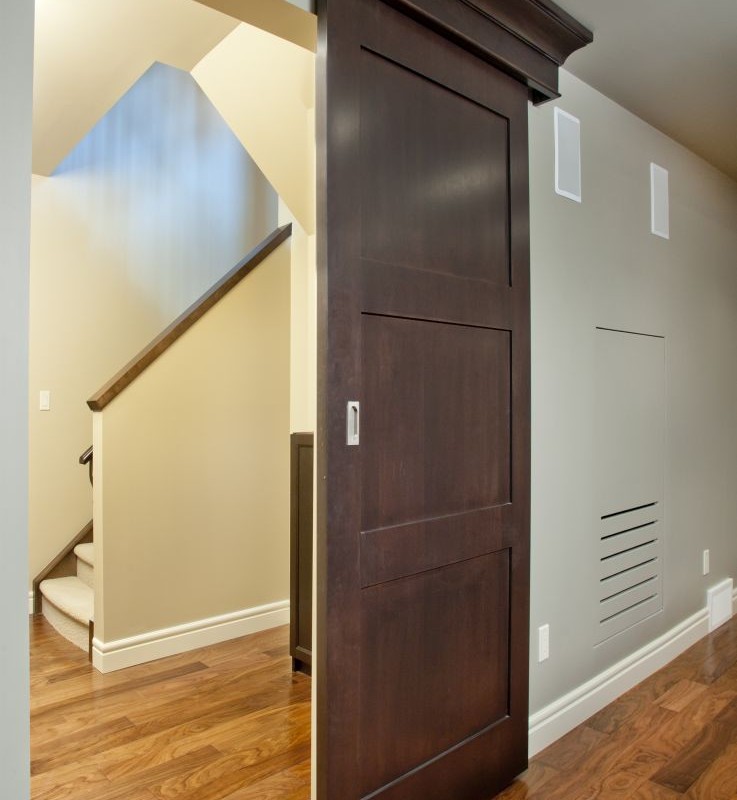 Wentworth Project By Renova Homes & Renovations In Calgary, Alberta pocket door leading into basement living room