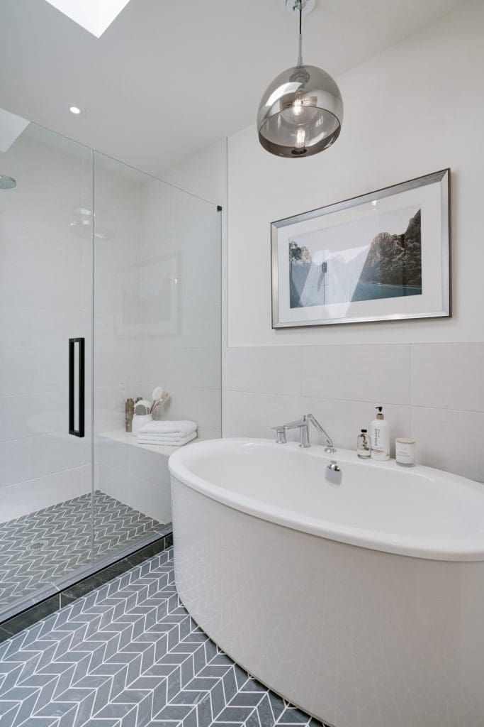 Arbour Lake Renovated Bathroom by Renova Homes & Renovations In Calgary, Alberta with tiled shower and soaker bathtub