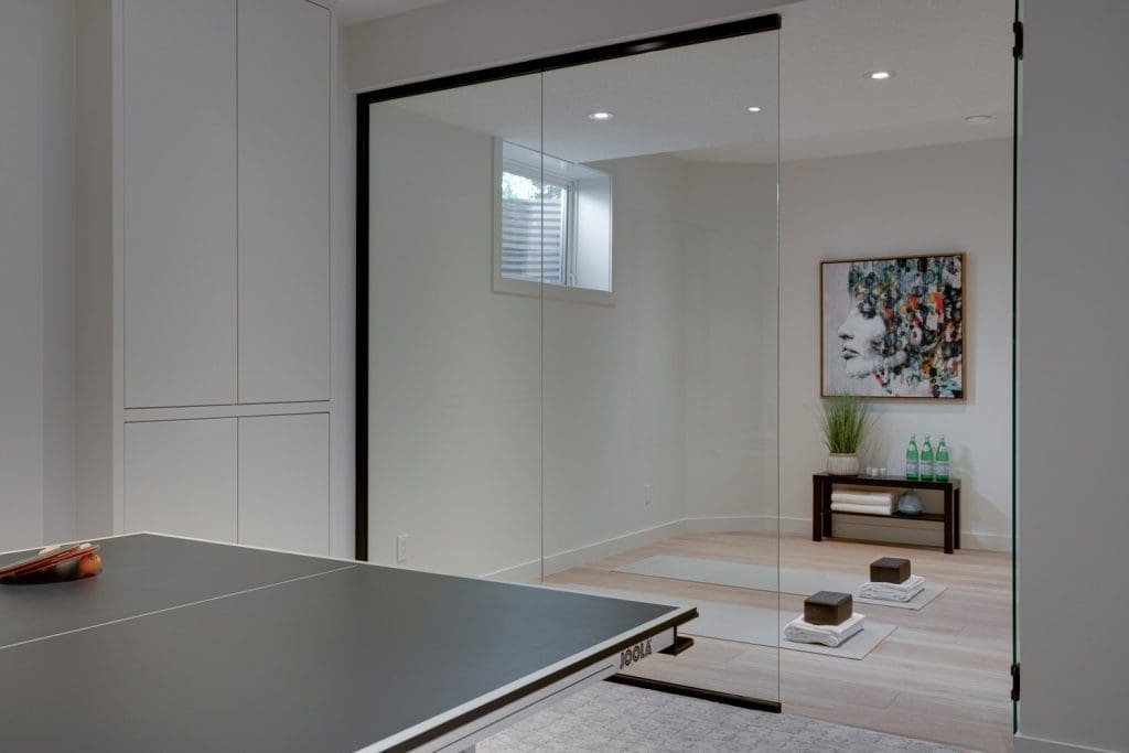 Arbour Lake Renovated Home by Renova Homes & Renovations In Calgary, Alberta Multi-purpose room with yoga mats and glass doors