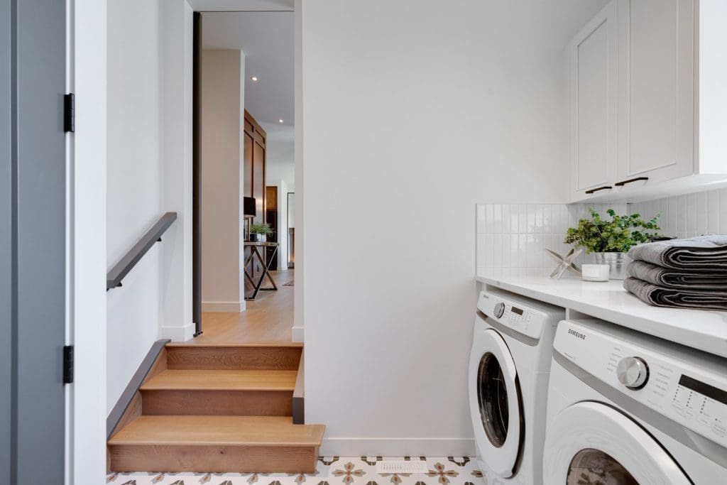 Arbour Lake Renovated Home by Renova Homes & Renovations In Calgary, Alberta laundry room with a pocket door