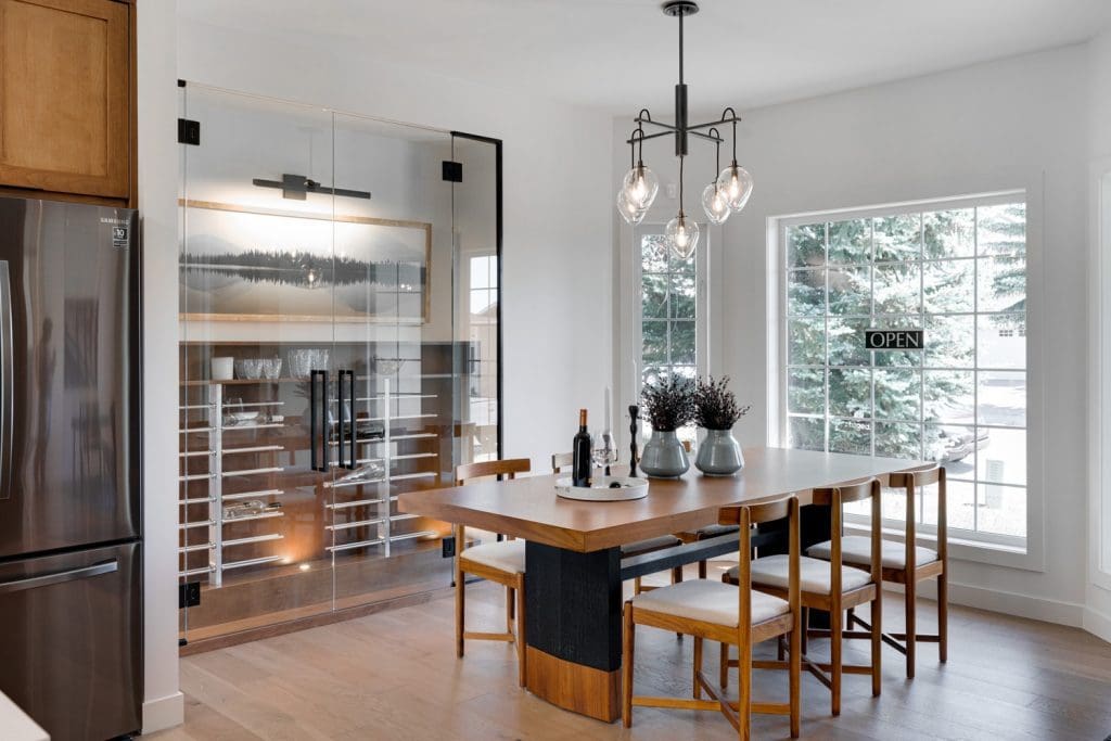 Arbour Lake Renovated Dining Area with 6 person dining table and wine room by Renova Homes & Renovations In Calgary, Alberta