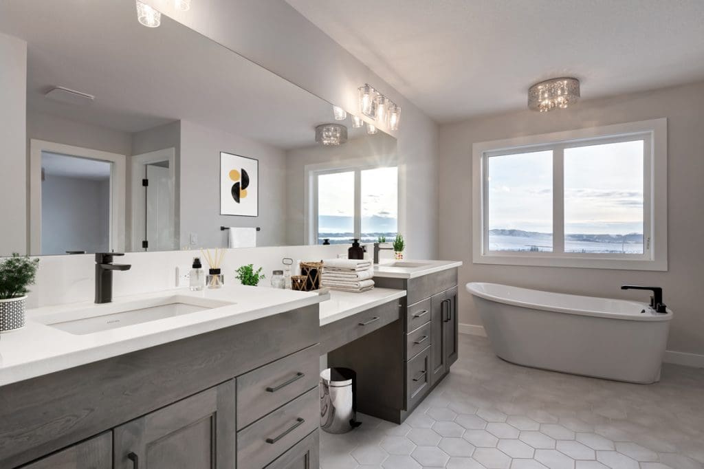 The Britannia Model Home By RENOVA Homes & Renovations ensuite with stand alone soaker tub and full vanity