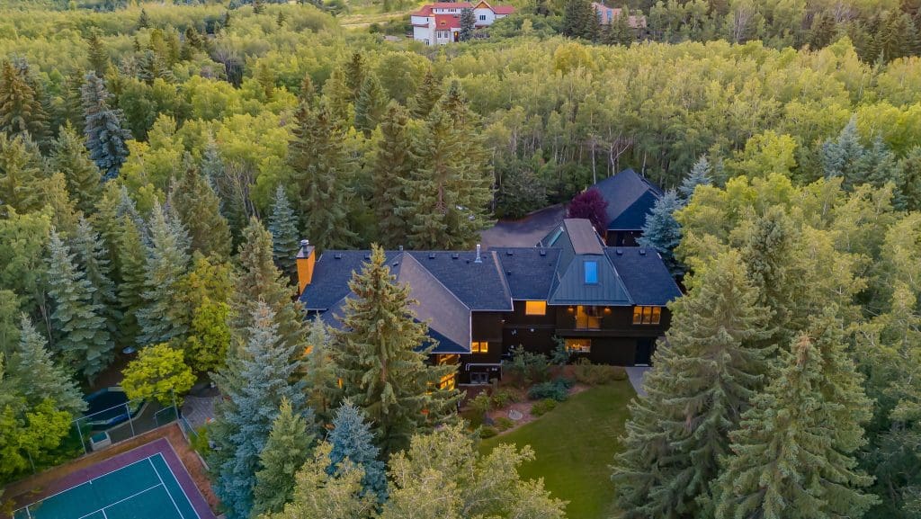 Springbank Renovation By RENOVA HOMES & RENOVATIONS Drone footage of house and tennis court