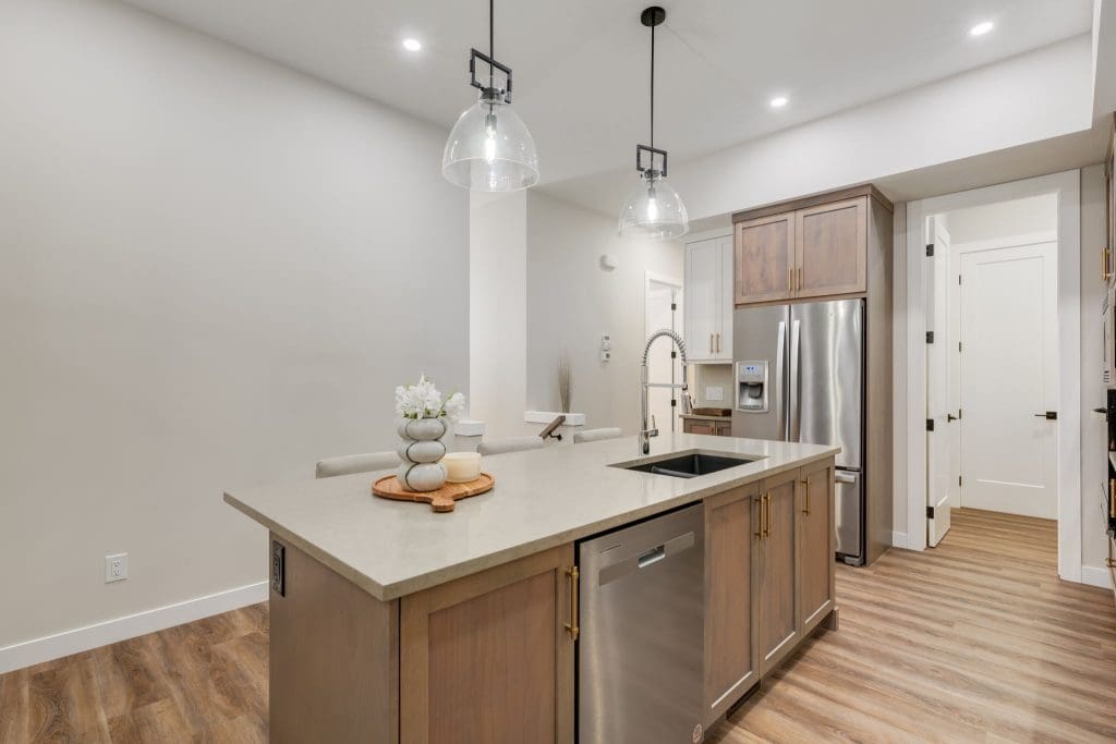 River Pointe Villas By RENOVA Homes & Renovations Kitchen Island with Light woof and metal hardwood