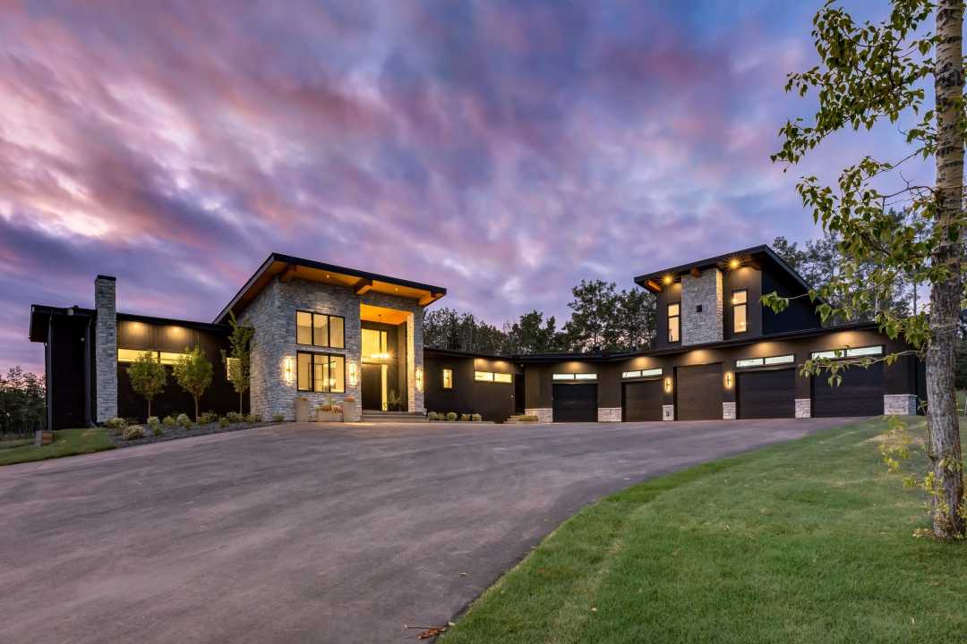Bearspaw custom home exterior at susnset Bearspaw Custom Build Exterior with landscaping at sunset